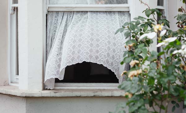 On a nice warm day, wind blowing and a curtain flowing with the breeze