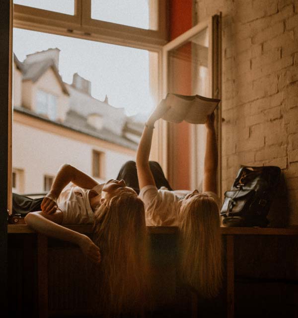 Girls enjoying reading in a relaxed setting 