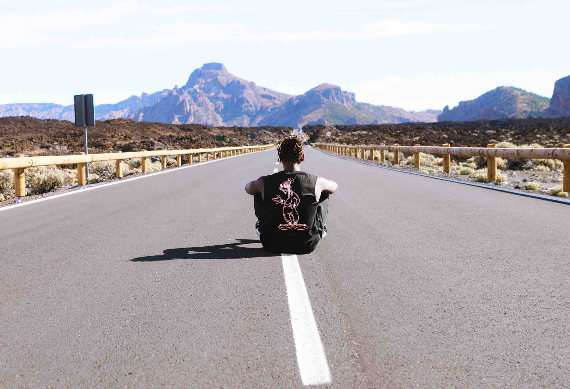 Boy sitting on road